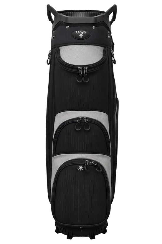 A black and gray Oxyx golf cart bag standing upright against a light gray wall and floor.