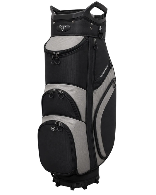 A black and gray OLYX golf cart bag standing upright on a gray carpeted floor against a white wall.